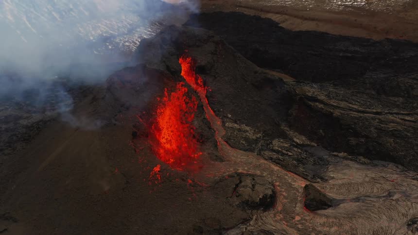 An aerial view of a volcano erupting