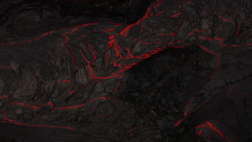 Lava glows red through cracks in gray matter on top