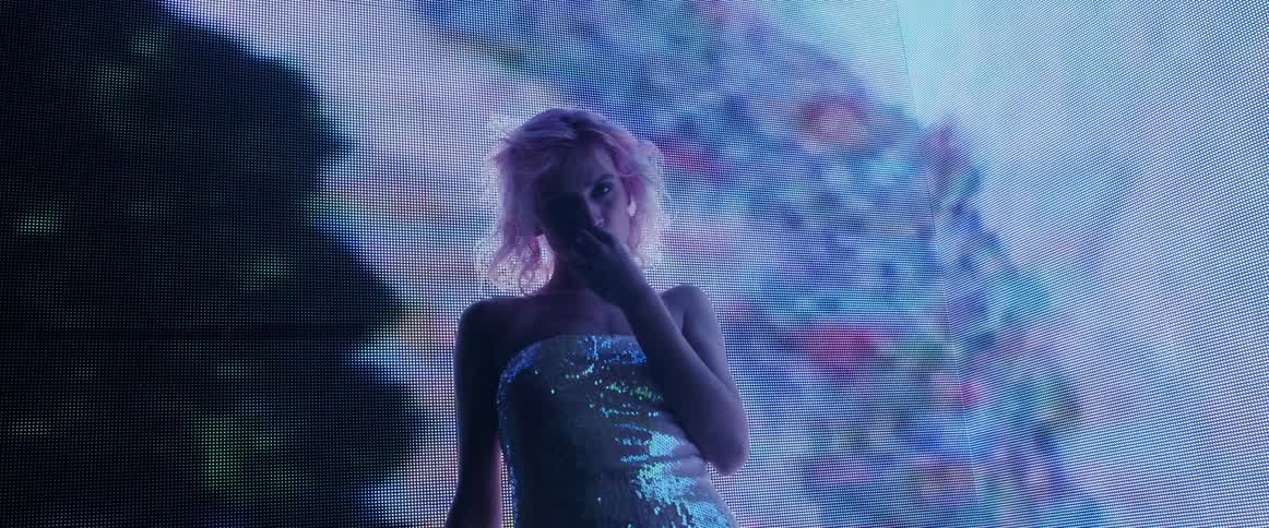 A portrait of a woman in front of a screen