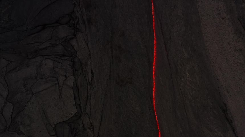 A birds eye view of a flare in a path on a rocky landscape