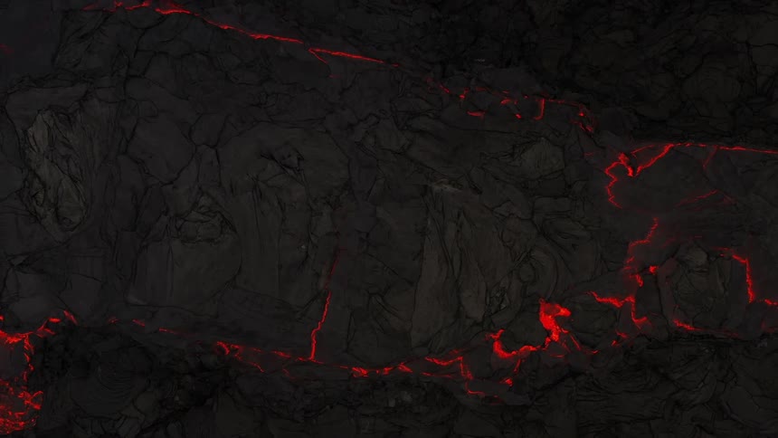 An aerial view of lava flowing as a volcano erupts