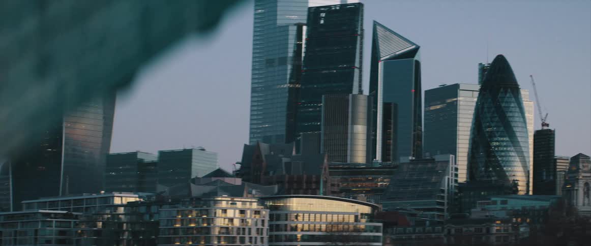 A city skyline with buildings and skyscrapers with the sky and clouds in the background
