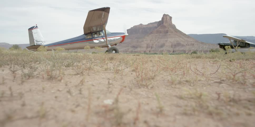 Small blue-and-white plane coming to a stop and turning