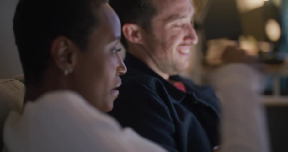 A man and woman are sitting on the couch together