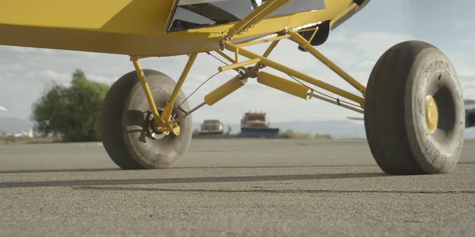 A yellow plane begins to take off