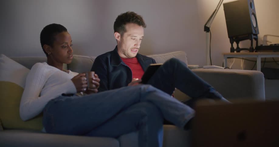 A man and woman are sitting on a couch together