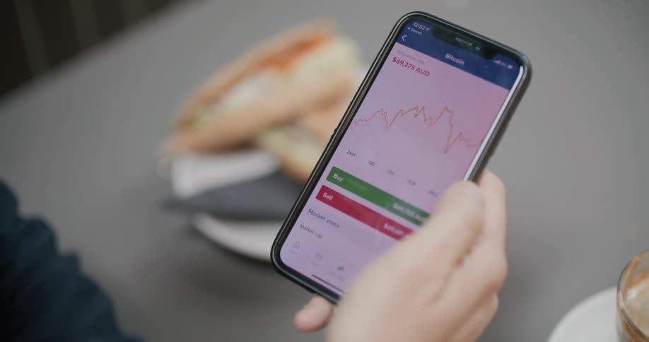 A person looking at graphs on a smartphone