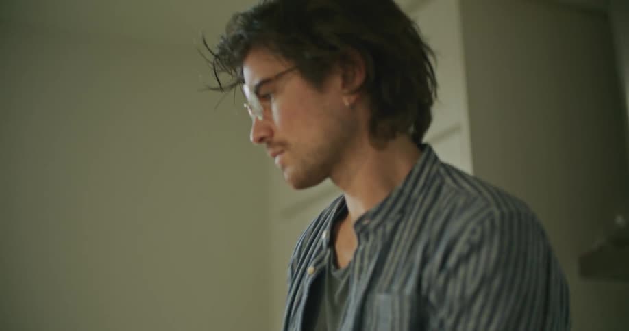 Young man prepares coffee in the kitchen at home