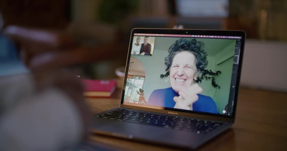 A woman talking on a laptop screen