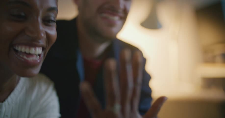 A man and woman happy showing off an engagement ring