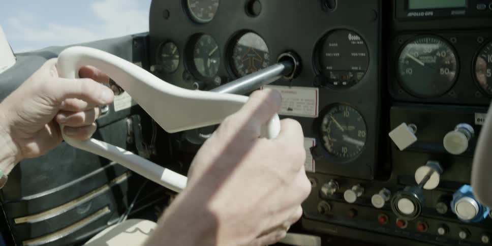 Close up of hands steering a plane