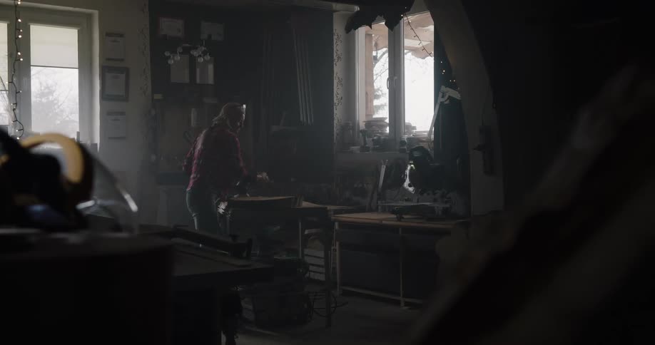 A woman carrying wood into a room