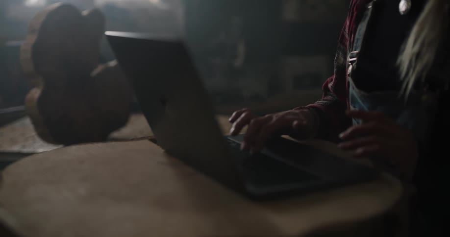 A woman at home uses a laptop