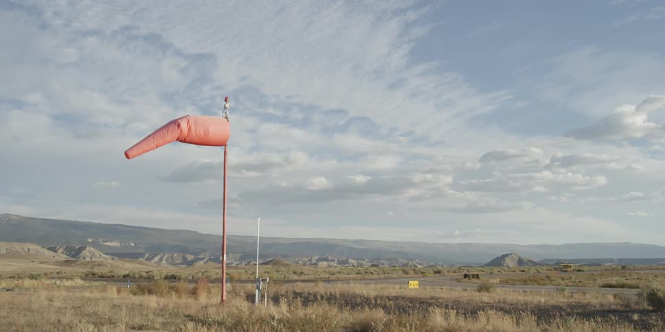 A pole has a flag waving on top