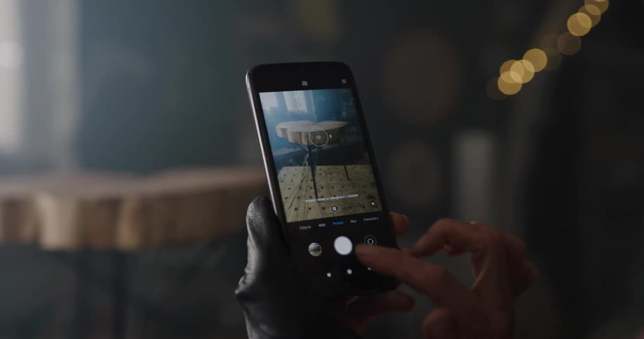A woman taking photos with her smartphone
