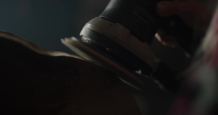 A person sanding wood