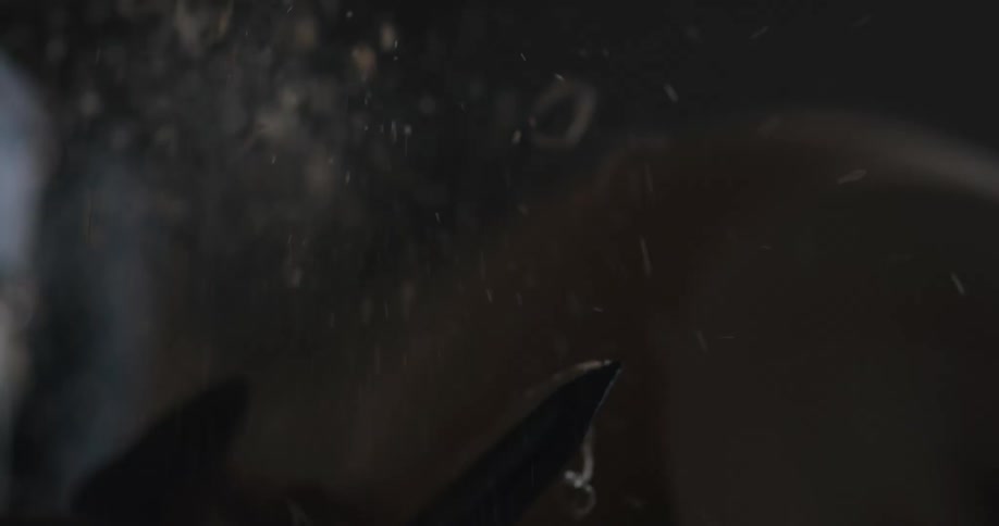A type of machine sawing a piece of material causing pieces to dust off into the air