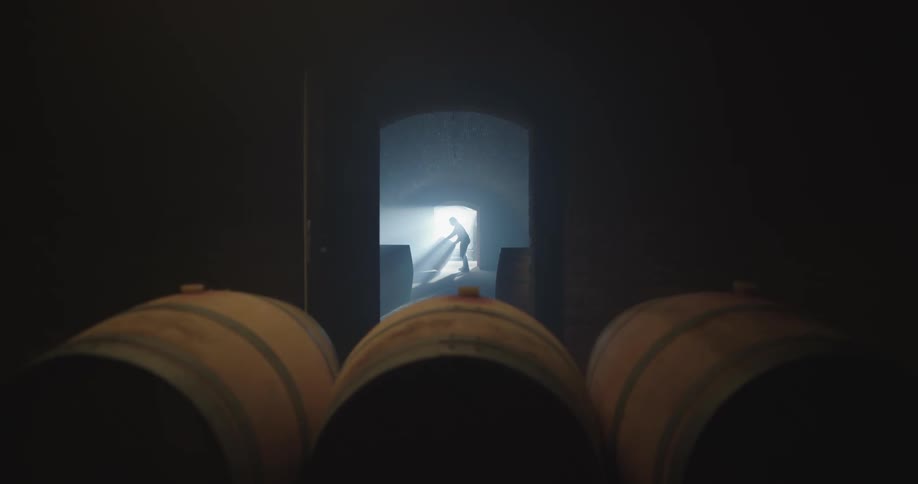 A person moving a barrel to a storage area