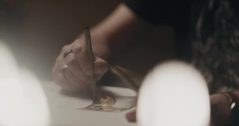 A person using a tool to put ink on a fabric