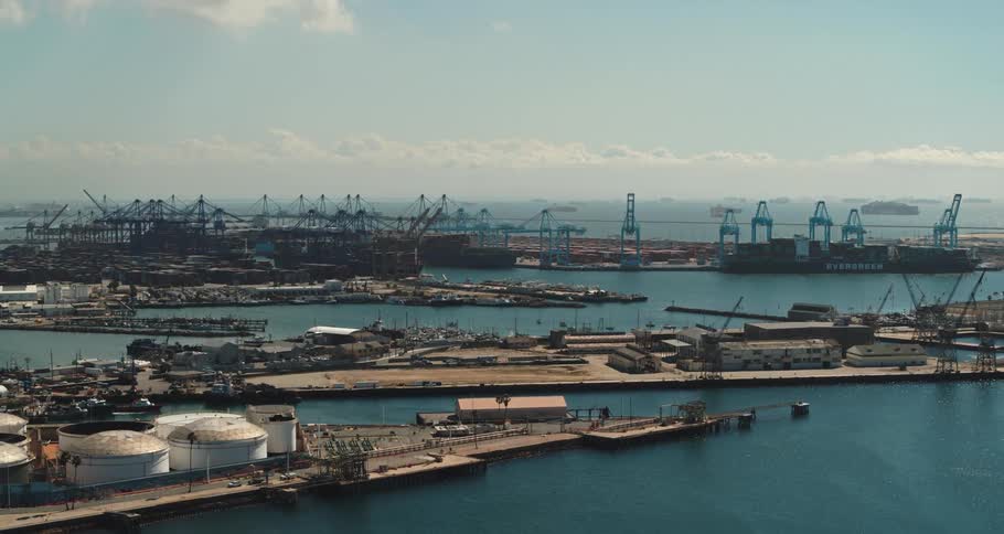 A port with buildings and shipping equipment during the day