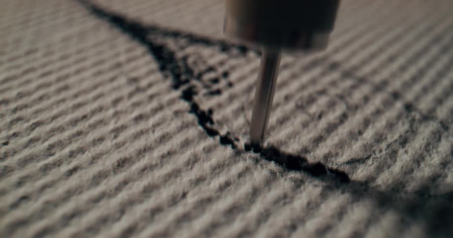 A machine quickly placing ink onto a piece of cloth