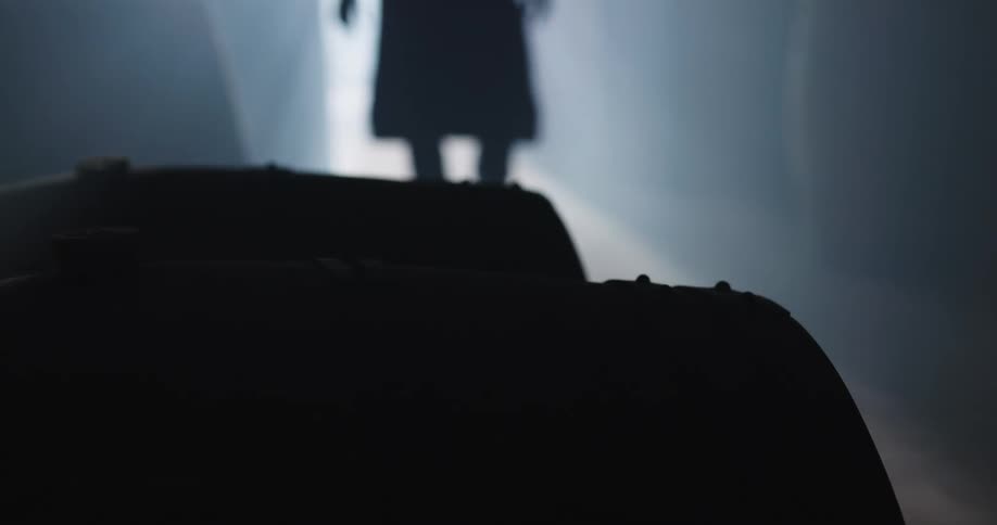 A person is walking into a warehouse building