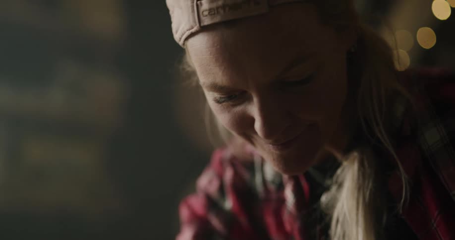 A woman smiles as she looks down