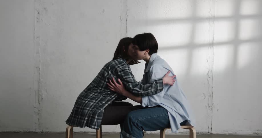 Two women touching and holding each other