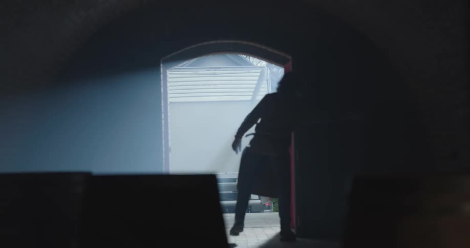 A male walking in a room shuts two doors and walks outside