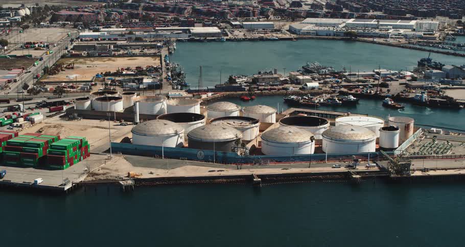 An aerial view of a port at the edge of a city