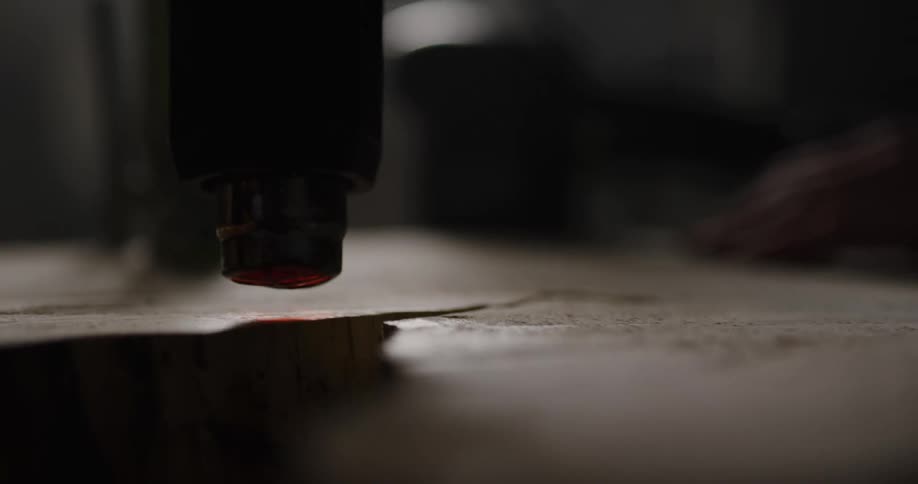 A machine is carving into a piece of wood