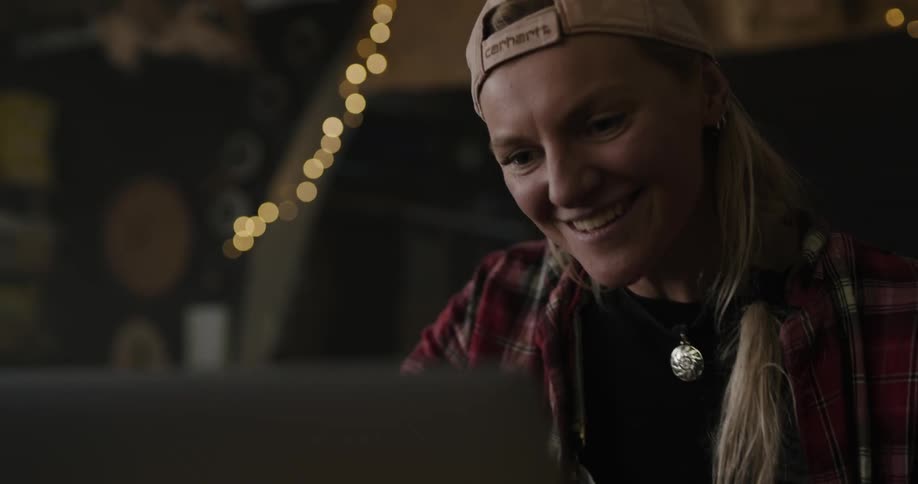 A woman is sitting in a room and smiling