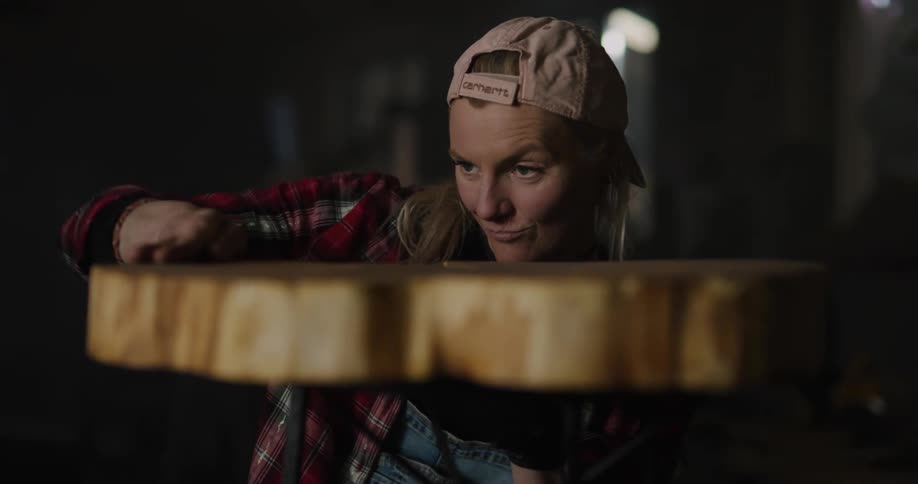 A woman that is very excited and touching a table