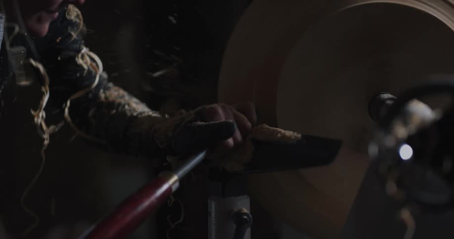 A woman working on wood in a shop