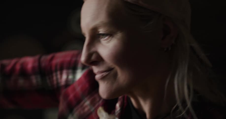 A woman sanding a piece of wood