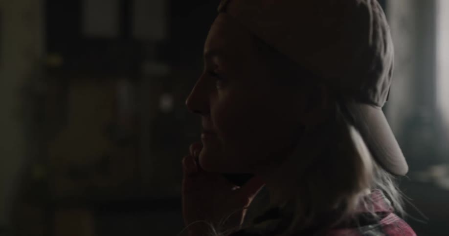 A woman at home talks on her cell phone