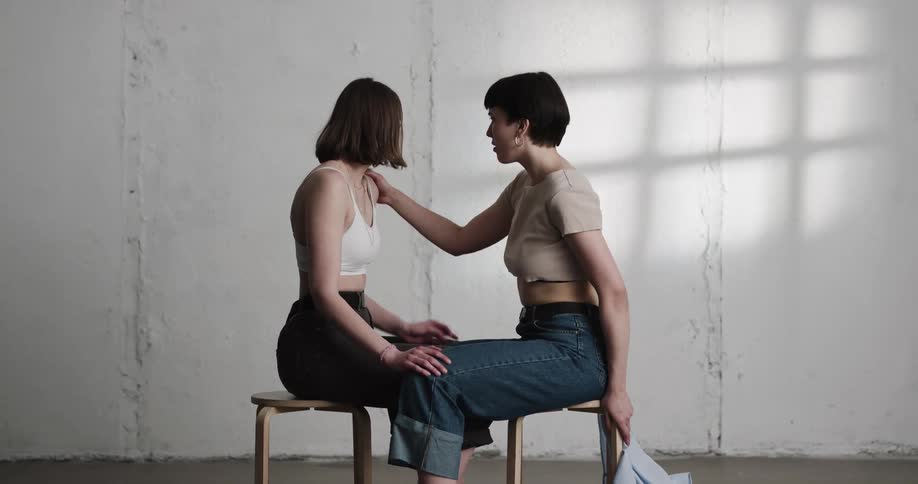 Two girls taking each others shirts off