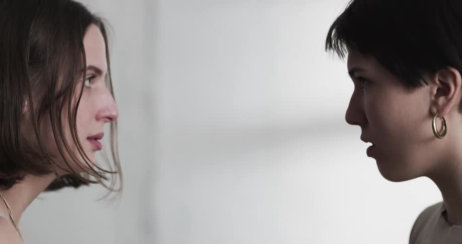 Two women undressing each other and gazing into each others eyes