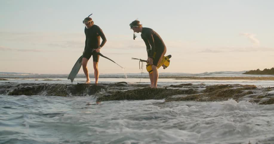 Father and son preparing to snorkel and spearfish