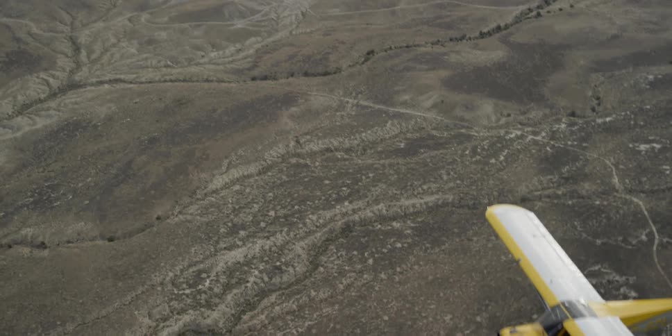 A plane is flying high over a field