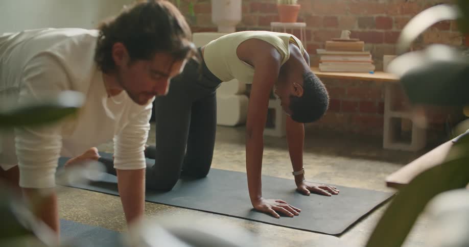 A man and woman doing yoga