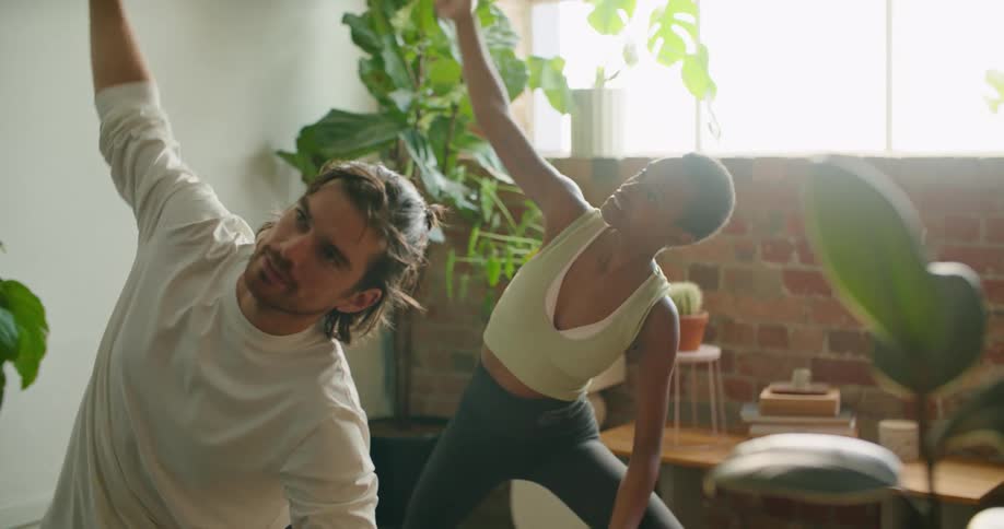 A man and woman stretching doing yoga