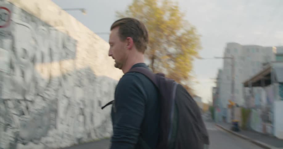 A man crosses a street in a city