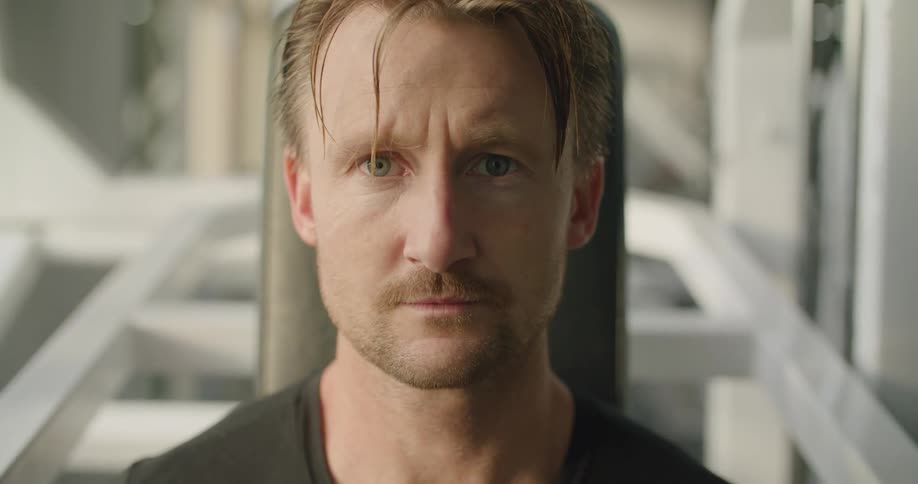 A man sitting in a room looking at the camera