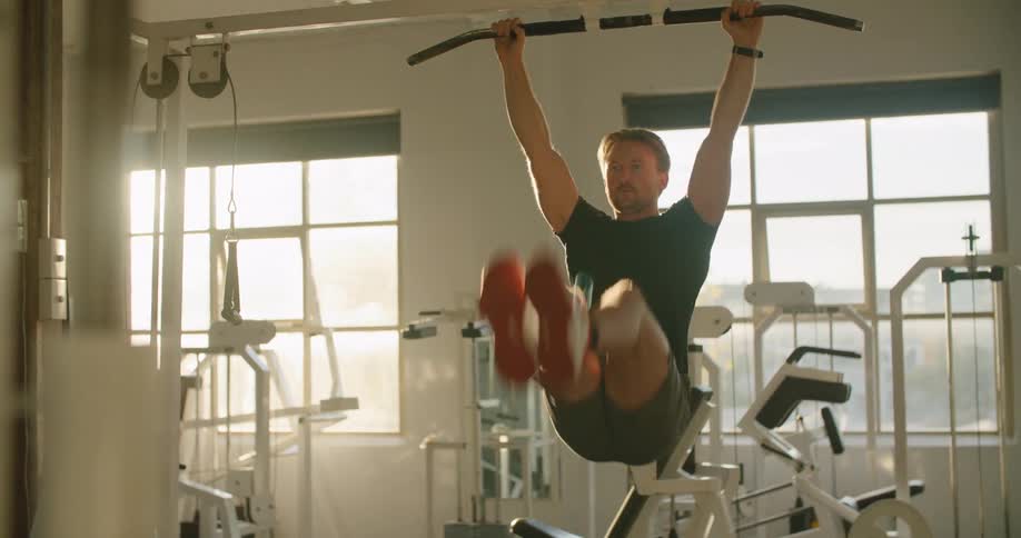 A man is using the exercise equipment in the gym