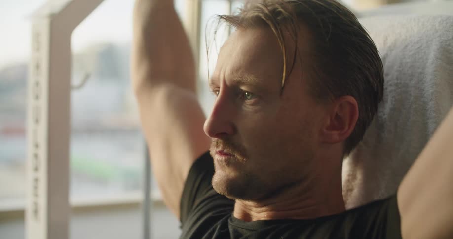 A man breathes heavy as he exercises