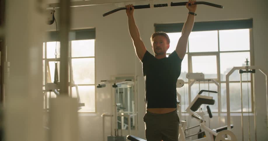 A man is working out in an empty gym