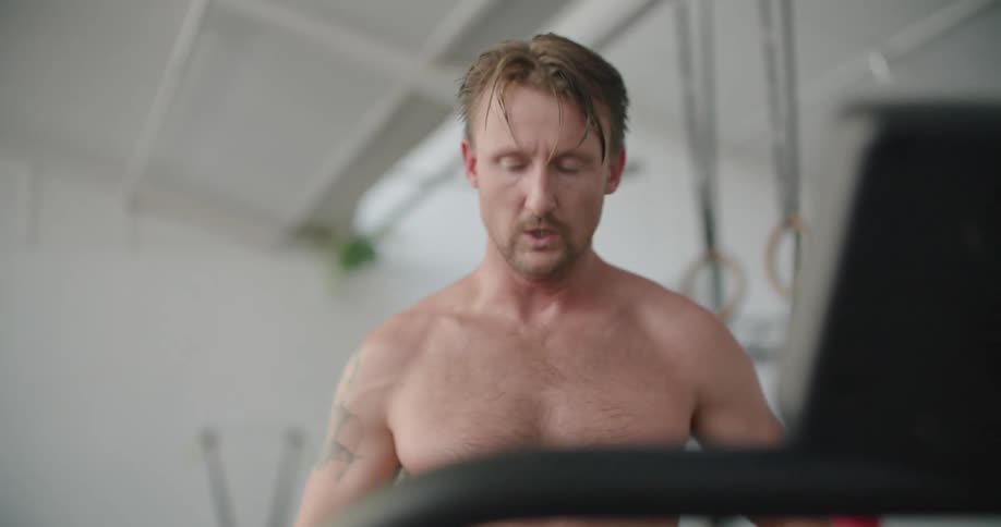 A man breathes heavy and tries to catch his breath after exercising