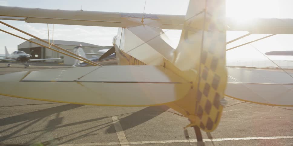 View of small airplanes and airport hangars