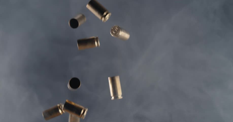 Bullet shells falling in a room with smoke